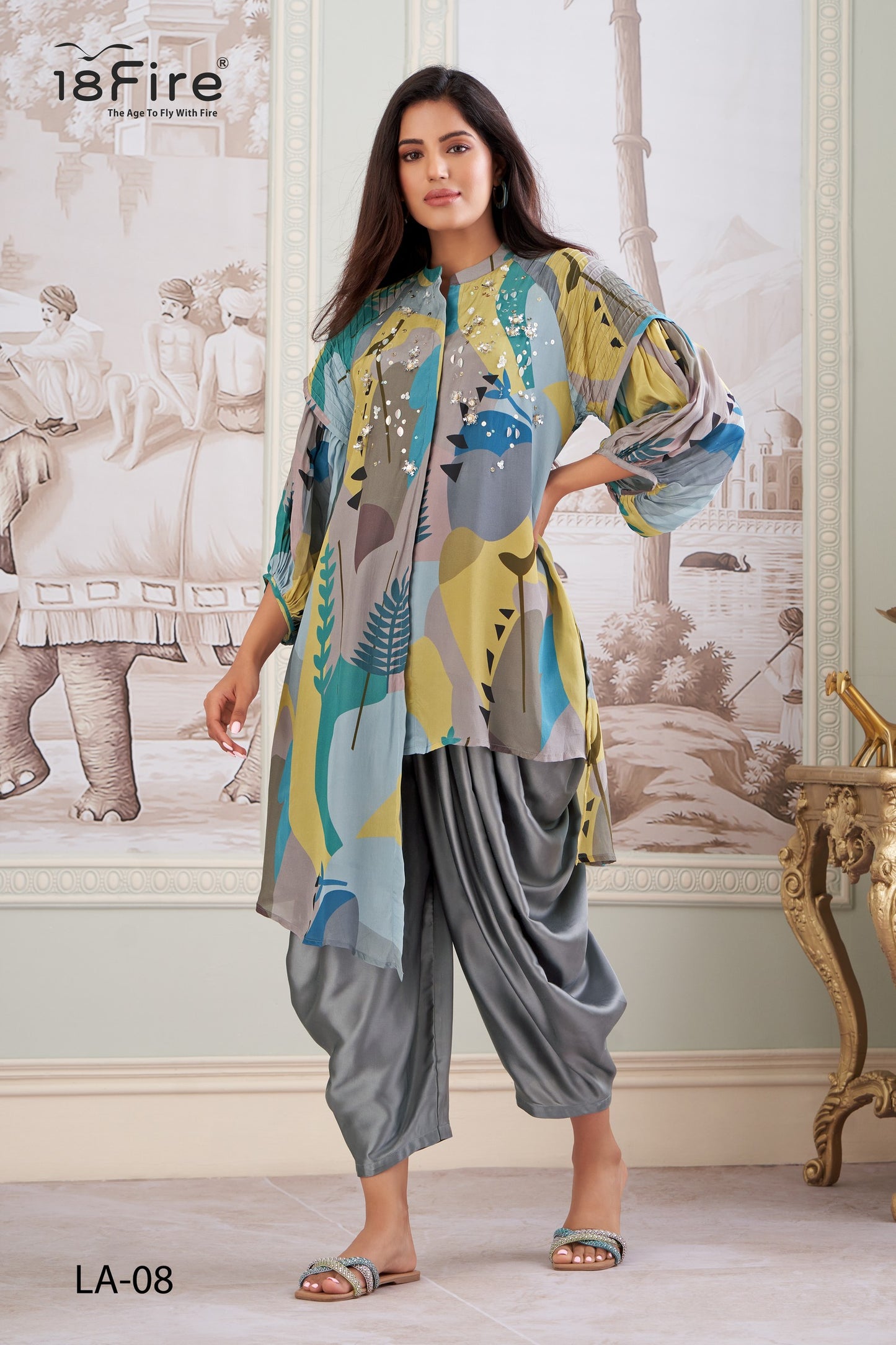 This outfit features a contemporary take on traditional Indian wear. The ensemble includes a digitally printed tunic with a mandarin collar, three-quarter sleeves, and an asymmetrical hemline, paired with draped dhoti pants (LA08)