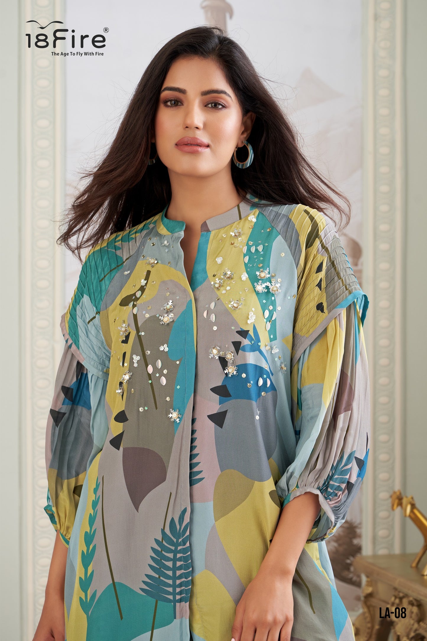 This outfit features a contemporary take on traditional Indian wear. The ensemble includes a digitally printed tunic with a mandarin collar, three-quarter sleeves, and an asymmetrical hemline, paired with draped dhoti pants (LA08)